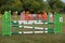 Colorful barriers on the ground for jumping horses and riders at riding school as a background.Obstacles for horses in a riding