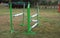 Colorful barriers on the ground for jumping horses and riders at riding school as a background.Obstacles for horses in a riding