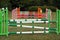 Colorful barriers on the ground for jumping horses and riders at riding school as a background.Obstacles for horses in a riding