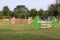 Colorful barriers on the ground for jumping horses and riders at riding school as a background.Obstacles for horses in a riding