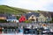 A colorful bayside village in front of boats in Dingle, Ireland.