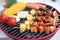 Colorful BBQ Grilling with pork ,sausage,tomato,onion,pineapple,chilli and corn on portable barbecue