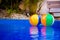 Colorful beach balls floating in pool