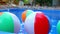 Colorful beach balls floating in pool