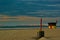 Colorful  beach cabin with the harbor Zeebrugge in the background