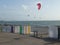 Colorful beach huts on the beach of Le Havre with kitesurf wings in the background, Normandy, France