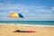 Colorful beach umbrella on the sandy beach on summer day. Naitho