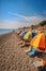 colorful beach umbrellas and empty sun loungers on the sand