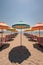 colorful beach umbrellas and empty sun loungers on the sand
