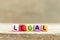 Colorful bead with letter in word legal on wood background