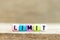 Colorful bead with letter in word limit on wood background