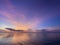 Colorful beautiful sunset, dawn with shades of pink, purple, blue. Calm sea with reflection of clouds in the water.