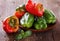 Colorful bell peppers over rustic wooden background