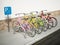 Colorful bicycles in bicycle parking area. 3D illustration