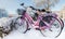 Colorful bicycles covered with snow after a snow fall