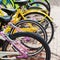 Colorful bicycles stand on a parking lot for rent