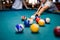 Colorful billiard balls on table in pub macro photo. Gambling concept