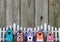 Colorful birdhouses by white picket fence