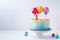 Colorful birthday cake with helium balloons.