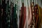 colorful blouses hanging on white hangers, arranged by color