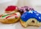 Colorful blue with bite, red, brown and stripes donuts with white background