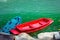 Colorful blue and red canoe boat in emerald green river