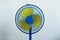 A colorful blue and yellow standing fan