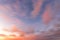 Colorful blured orange-purple dramatic clouds lit by the setting sun against the evening sky