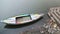 Colorful boat anchored in dirty bay of Ganges, with man standing at dock.