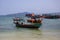 Colorful boat on seashore. Traditional wooden boats. Koh Rong island harbor landscape. Cambodia travel photo.