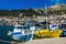 Colorful boats: blue-white and yellow in Greek port