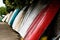 Colorful boats lean against the wall in English country sea side with boats and mountain view.