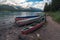 Colorful boats by Maligne lake, with Samson peak, Maligne mountain and Mount Paul in the background. Summer in Maligne valley of