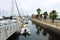 Colorful boats in marina with clouded skies and blue sky peeking out from behind the clouds