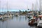 Colorful boats in marina with clouded skies and blue sky peeking out from behind the clouds