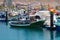 Colorful boats packed into the harbor and marina at Los Cristianos ferry terminal in Tenerife on a hot summer day