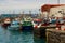 Colorful boats packed into the harbor and marina at Los Cristianos ferry terminal in Tenerife on a hot summer day