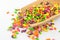 Colorful bonbons mix in wooden spoon