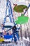 Colorful booths of ferris wheel under the snow. vertical.