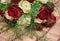 Colorful bouquet of white and red roses on bege bamboo straw mat, close up