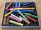 A colorful box of artist chalk showing all different colors.