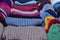 Colorful bright background of woolen fabric sweaters and hats