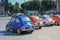 Colorful bright group of  Italian small classic vintage subcompact cars Fiat 500  parked  on one of famous square of Rome