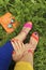 Colorful bright manicure and pedicure in different pink and orange sandals