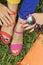 Colorful bright manicure and pedicure in different pink and orange sandals