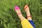 Colorful bright pedicure in different pink and orange sandals and different blue and yellow pants