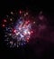 Colorful bright red and blue fireworks and smoke in the night sky background