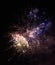 Colorful bright red and blue fireworks and smoke in the night sky background