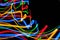 Colorful bright red, yellow, blue and green mixed Christmas lights flowing in various directions