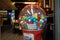 Colorful bubble gum in Coin operated gumball machine. Carousel Gumball Machine Bank kept outside a shop. - Dubai UAE January 2020